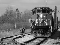 On this sunny day, I dang near killed myself trying to photograph this surprise. Ex-CN, now RMPX 9431 (now part of the Southern Ontario Railway fleet), pulled a short six car mixed freight south through Hagersville. I first caught glimpse of this freight on 1st Line, pulling out from a gas station. I was so excited when I grabbed my camera, that I forgot to pay attention to traffic and almost veered completely into the opposing lane. After re-composing myself and following this train to the south end of town, I caught both conductors disembarking the locomotive at the County Road 9 crossing. They were preparing to drop the six mixed cars into the siding.