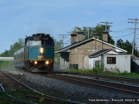 On this early spring evening, I made a stop at one of my favourite locations. Here, westbound VIA train 67 blows by the empty sidings and the restored Grand Trunk stone station in Prescott. 