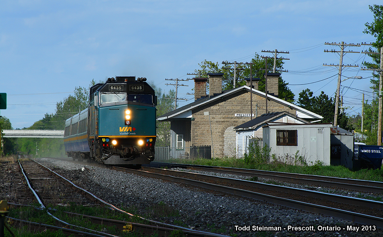 On this early spring evening, I made a stop at one of my favourite locations. Here, westbound VIA train 67 blows by the empty sidings and the restored Grand Trunk stone station in Prescott.