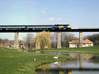 VIA #83 with an FP9 leading two classic blue-and-yellow ex-CN cars crosses the high bridge over Trout Creek, at St. Marys ON on the CN Guelph Sub (former Thorndale Sub from Stratford to London).