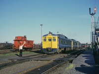 There are no passengers to board tonight at Rockingham as the operator hands paperwork up to the engineer on Via RDC-1 6107. I am not 100% certain but believe that this is the train to Sydney. 