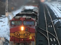 You had to be here for this one. It was a memorable experience.....a heads up via the internet...from what I remember it was a BNSF(Santa Fe)/NS/BNSF/CN conglomeration....as the last light was fading....I could see him dimming his headlight in the distance as an passenger train was lined up in the other direction...would I get doubled?...391 slowed to a crawl way back at Waterdown Road...I was thinking the daylight would disappear before he ever gets here and no shot....suddenly....I could see the heat and exhaust pouring out of the locomotives in the distance; and luckily he kept the ditch lights off; the telephoto effect did not do this one justice as he blasted by me..with that beautiful Santa Fe logo still on the front....

Does anyone know if this unit is now a CN 21xx ?