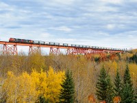 Swan Landing-Grande Prairie loaded sand train X45851 30 crosses the Smoky River just south of Shaver on CN's Grande Cache Sub. On the headend of the short (3865') but heavy (12060 tons) train is CN SD70M-2 8934 and SD75I 5796. Shoving on the rear was SD70M-2 8826 and C44-9W 2689.