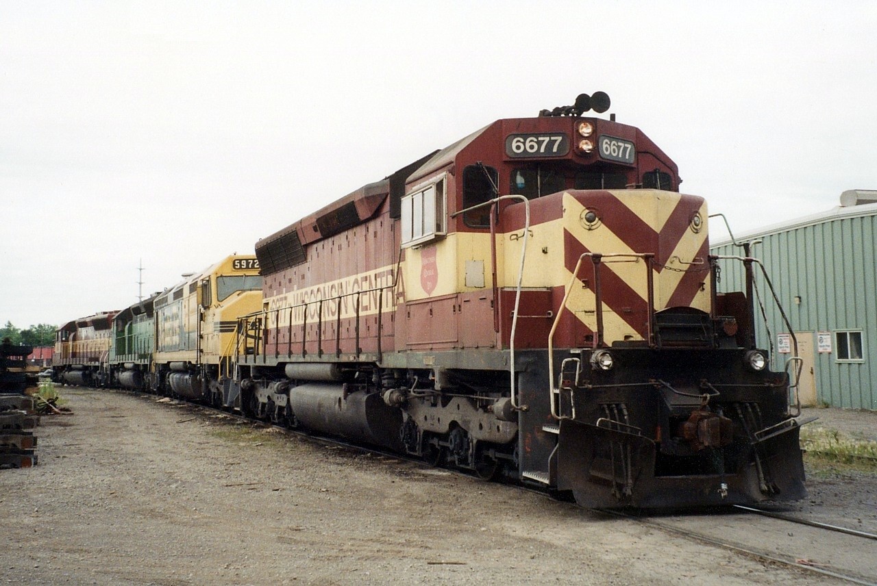 WC 6519, WC 6494 (still in BN green), WC 5972 (in full ATSF paint), and WC 6677 sit outside the Algoma Central shop in Sault Ste. Marie, ON.  Shortly after the photo was taken the power departed for the yard to put together a northbound train.  WC 6677 was one of only a few WC locomotives to receive stripes on the nose rather than the standard pine tree nose design.