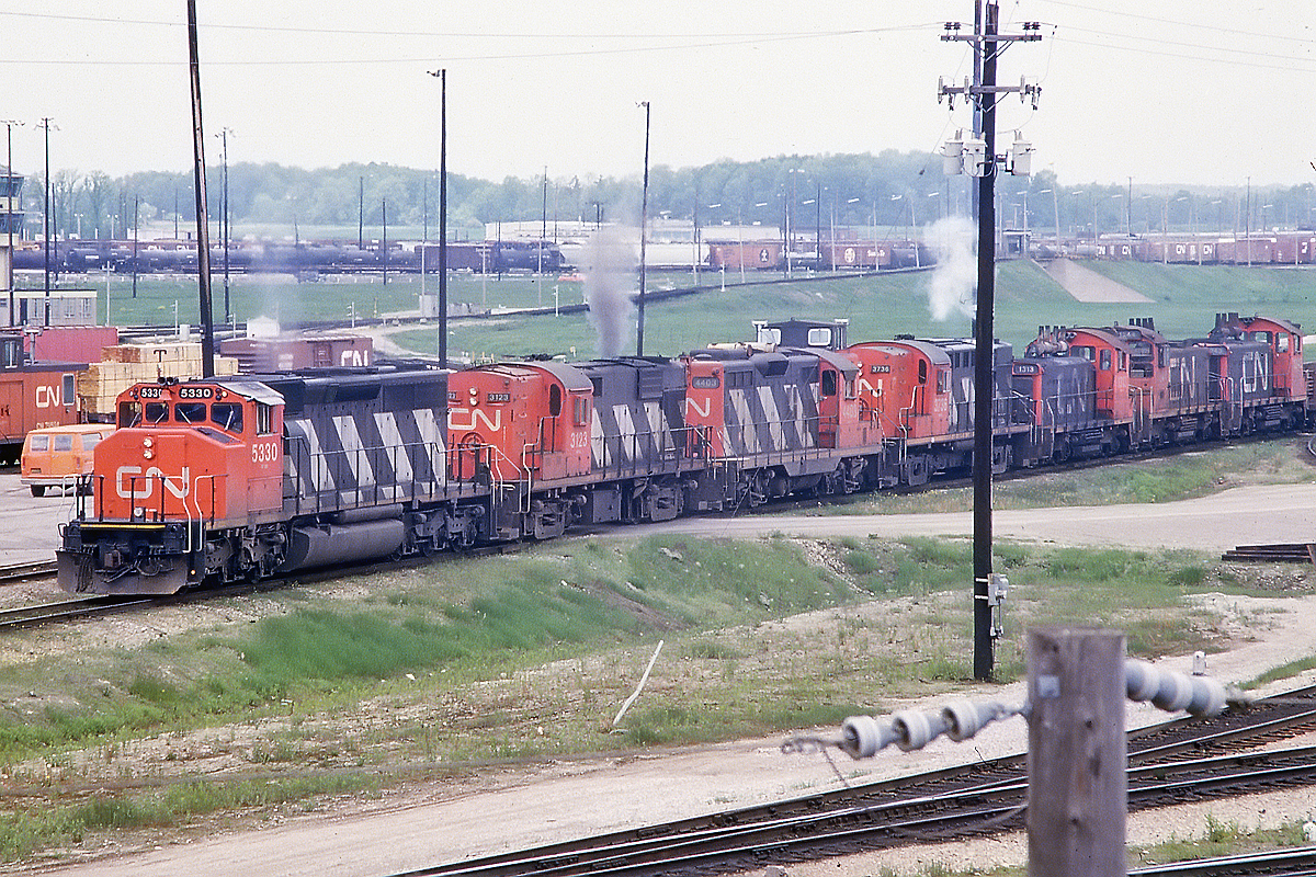 A lashup to dream of. 318 did work everywhere, so the SW1200's probably ended up there. But mixing an SD40-2 (which was rare in Toronto in those days) with 2 RS18's and a GP9 was pretty special. I wonder how it sounded on the Kingston Sub?