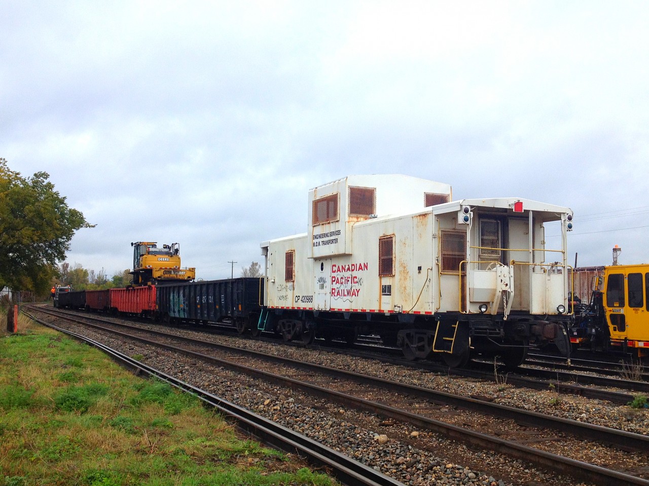 CPR M.O.W Caboose #420988 rests with a work train near Central Grain on the CP Emerson Subdivision at St Boniface Yard. At the head-end there was a Brant Truck coupled to the train.