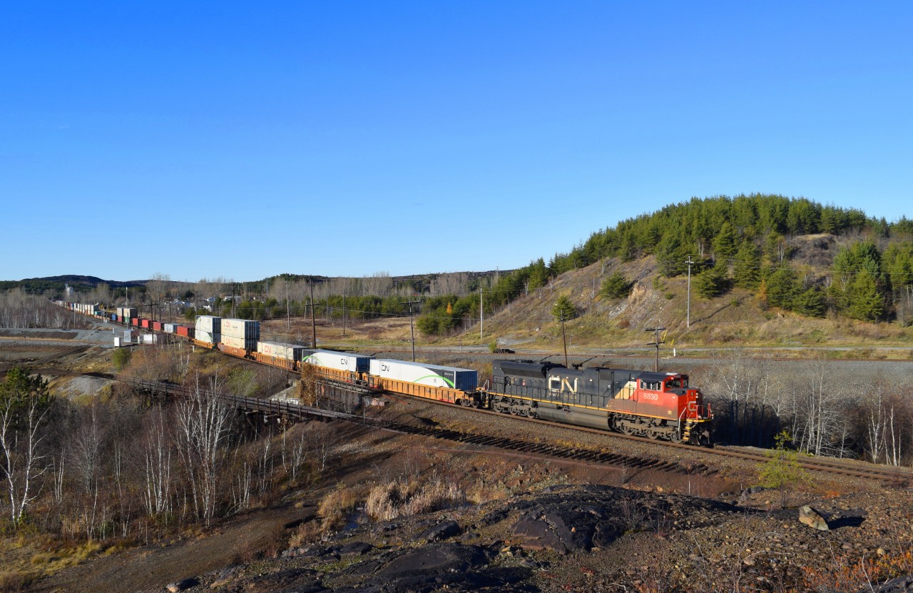 SD70M-2 8830 leads train 106 through Coniston with ES44DC 2233 helping out mid train.