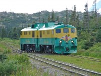 GE shovelnose units WPY 97 and 91 have reached the south siding switch at Fraser BC, having run around their train. After rejoining the main line and changing the switch, they will back down onto their tourist train for the return trip to Skagway Alaska.  Canadian border bontrol formalities are not required unless you pass beyond (north of) Fraser.  With the paving of the parallel Klondike Highway, mine closures, conversion to trucks, national border and other considerations - there is very little WPY traffic beyond Fraser in recent years. A high percentage of WPY passengers are tourists on day trips from cruise ships that spend one day in Skagway. 