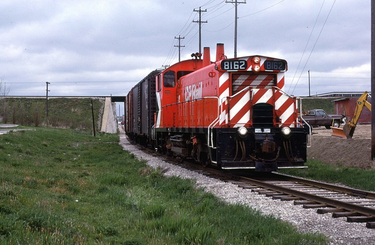 On yet another overcast day in May of 1980, CP's switch job on the Waterloo Sub runs south, passing under CN's Guelph Sub.
CP would switch the Seagrams Distillery and a very small yard just to the NW of the distillery. I only rarely saw this operation - not having the patience to wait around, and radio or access inside information. It wasn't until I saw the photos by Greg MacDonnell in one of his books that I realized what an idiot that I was.
CN had a spur that ran up to Elmira. I walked over that track almost daily and I never photographed that operation - dumbass that I am.