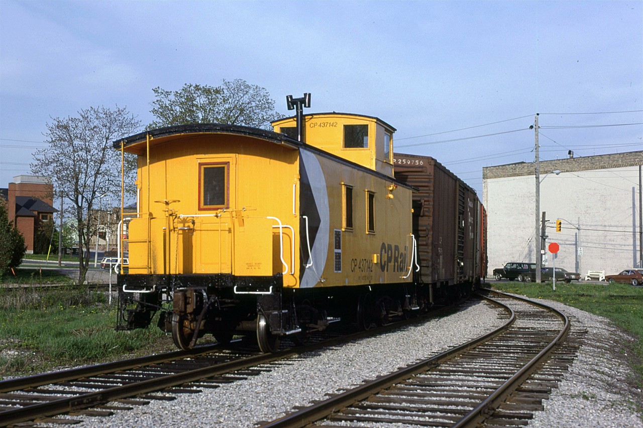The rear end of the CP switch job at the end of the Waterloo Sub. 
Traffic is stopped at Erb Street (on the right) and Caroline (on the left).
The tall building on the right is part of Seagrams Distillery.
CN's track to St Jacobs and Elimra is on the left.