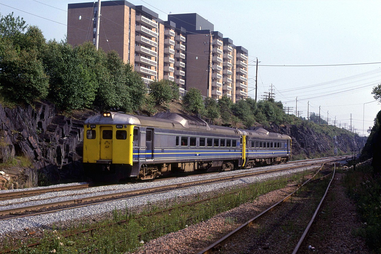 A westbound RDC train passes Southwestern Junction on the Bedford Sub. The track in the foreground is the Chester Sub.
A twin to the apartment building that is just out of frame to the left is the one that overlooks the Fairview Shops.