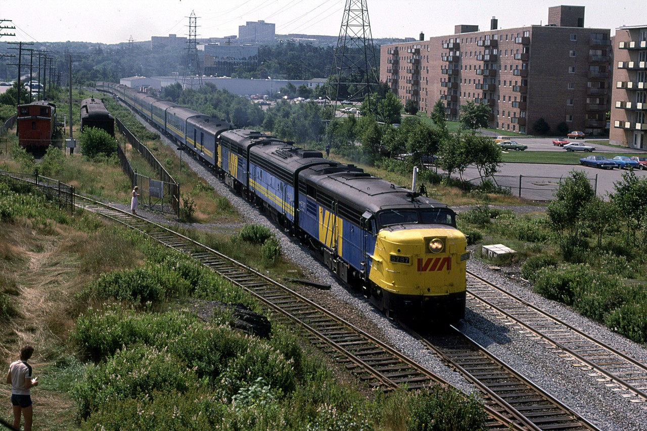 The westbound "Atlantic" has just passed Armdale and is about to go under Mumford Road.
The second unit, a F-9B, was rather unusual for Halifax. 
The gated track to the left leads to the Simpson-Sears warehouse and store. It seems to always be filled with CP boxcars.
The historic rail equipment is a complete mystery to me. I do not even remember ever looking at it.
Note the well used path/trail across the tracks. It is one of many along this stretch of tracks. RR's weren't quite as anal back then.