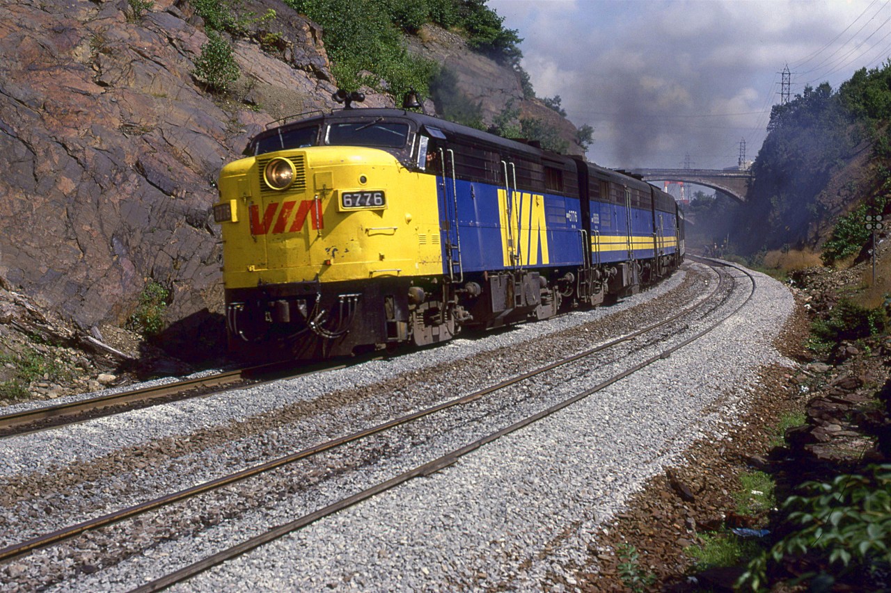 The westbound "Ocean" accelerates out of the Halifax terminal at 1330hrs. I was first bathed in diesel exhaust and then dust from the fresh ballast as the train went by.
The bridge in the background is for Tower Road.