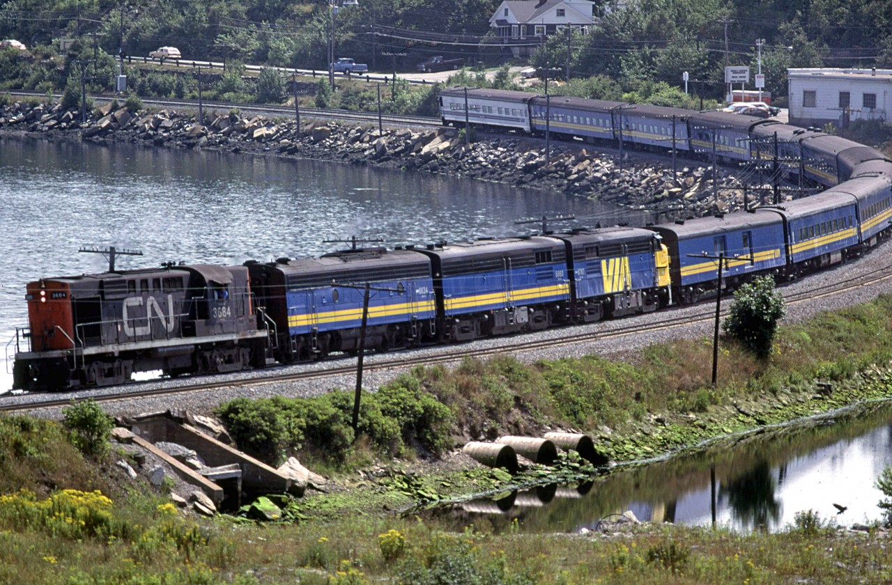 The wEstbound "Ocean" rounds Mill Cove with a RS-18 leading this day. There must have been issues with the trailing FPA-4 because Fairview Shops could have easily put it on the lead. Perhaps it was the engineer's choice?
This area is quite different now. A lot of the pond on the right has been filled for a Superstore, and they are filling in the Bedford Basin on the left.