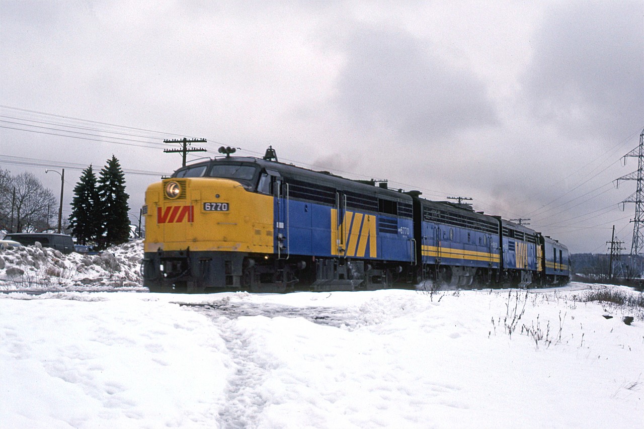 On the day before Christmas, the weatbound "Atlantic" glides by Armdale as it exits Halifax.
The middle "B" unit is an EMD product.
Note the large piles of snow in the background and that the platforms for the Armdale whistle stop "station" are cleared.