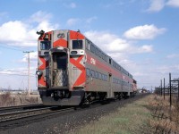 The rear end of an eastbound commuter train races by.
These cars look a lot like those used in Chicago, I belive.
