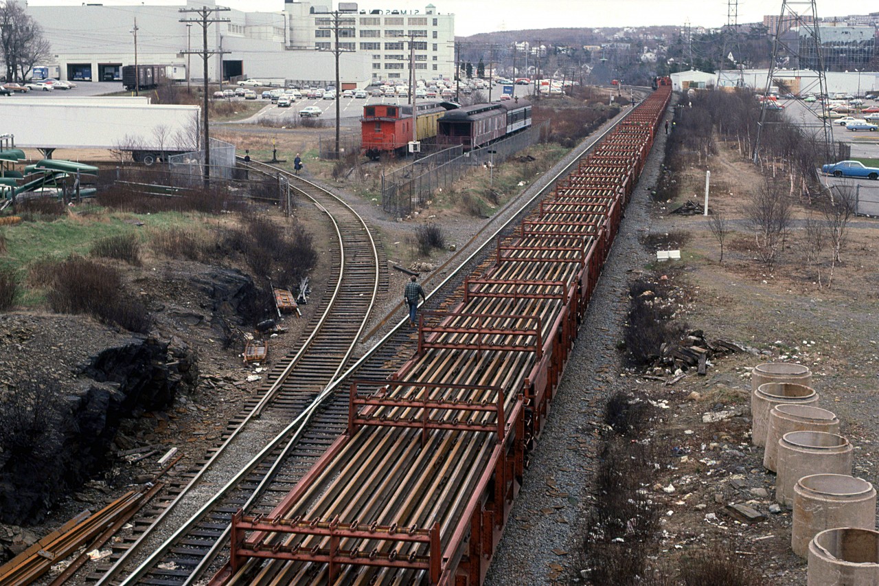 An overhead view of the ribbon rail train as it is unloading t Armdale.
Simpson-Sears is the large white building. Note the green "SIMPSON'S" sign on top. Also note the blue Sears trucks at the bays.
For a change, there are CN boxcars at the track bays.
The historic rail equipment is looking rather forlorn.
I am rather appalled by all the trash along the RR ROW.