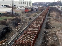 An overhead view of the ribbon rail train as it is unloading t Armdale.
Simpson-Sears is the large white building. Note the green "SIMPSON'S" sign on top. Also note the blue Sears trucks at the bays.
For a change, there are CN boxcars at the track bays.
The historic rail equipment is looking rather forlorn.
I am rather appalled by all the trash along the RR ROW.