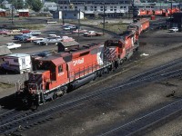 An interesting array of power - Sd-40's an high nose GP-9 and a couple covered wagons - comes out of the servicing bay at Alyth Shops.