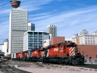 An eastbound manifest train pulls through downtown Calgary.