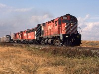 This is probably the most interesting consist that I ever caught on the CP. I would not spend nearly enough time on the east side of Calgary where such occurrences would be much more likely. These locomotives would be turned and sent back east any time they made it this far west. SD-40's (and a few GP's) ruled beyond Calgary.
I guess that this area is not a container terminal. Cross-bucks in the distance are for a very rural 52 St SE crossing.