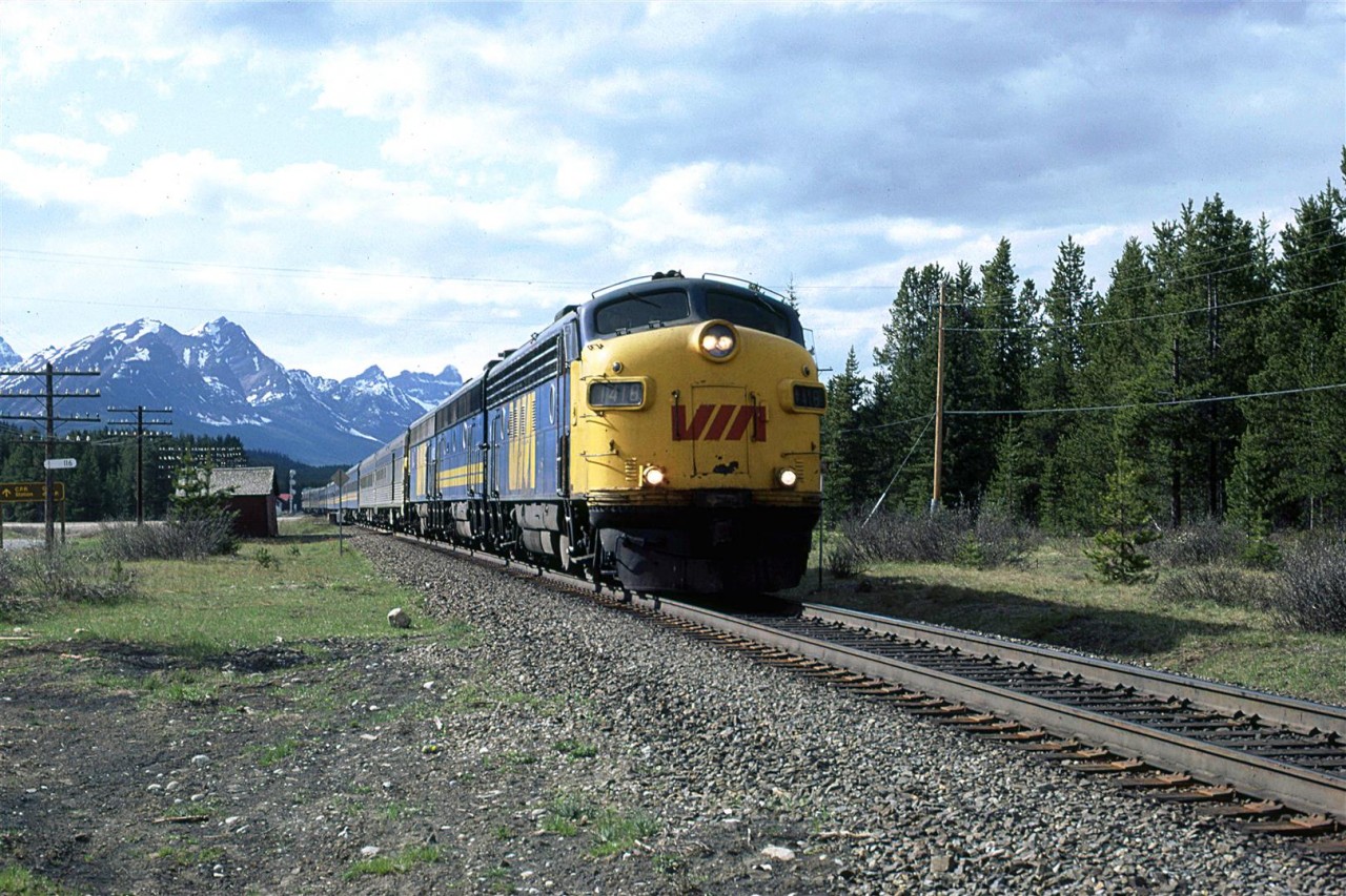 The westbound "Canadian" runs through Lake Louise. The red roof of the station can be seen in the background.