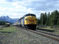 The westbound "Canadian" runs through Lake Louise. The red roof of the station can be seen in the background.
