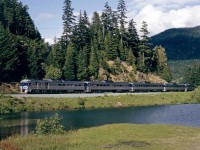 BC Rail daily passenger train passing a small lake just south of Whistler, BC in June 1993 with 6 RDC's.  This was one of the best rides in North America with premium Caribou service that included better seating and meals at your seat.  In early 1993 when I rode it, a round trip Caribou service ticket from North Vancouver to Lillooet was $97 compared to the regular fare of $52.  If both sides were on time, there was about a 3 hour layover in Lillooet. 