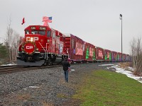 A father introduces his young daughter to the motive power of the 2014 CP Holiday Train while stopped in MacTier, readying for its performance on a soggy and grey November afternoon. 