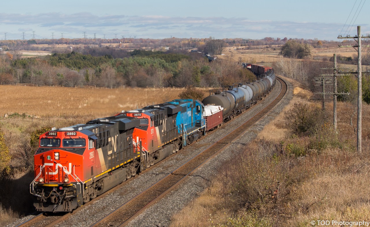 CN 305 comes through Newtonville on a wonderful Fall afternoon, with a special unit trailing third. A blue GP40, LLPX 2269, trails third behind a pair of GEVOs. (1:51pm) 

(CN2892, CN2870, LLPX2269, DPU CN2866)