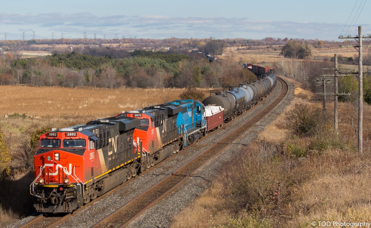 CN 305 comes through Newtonville on a wonderful Fall afternoon, with a special unit trailing third. A blue GP40, LLPX 2269, trails third behind a pair of GEVOs. (1:51pm) 

(CN2892, CN2870, LLPX2269, DPU CN2866)