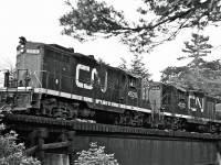 Built in 1956, a couple of EMD GP9s are seen working their way through Toronto’s Don Valley.  
<br />
<br /> 
Locomotive #4520 would be rebuilt in 1993 as Slug 278.
