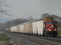 Dwarfed. You don't realize how tall those auto max cars are...until a large cut dwarfs the power...here CP 427 heads east on the CN at Aldershot