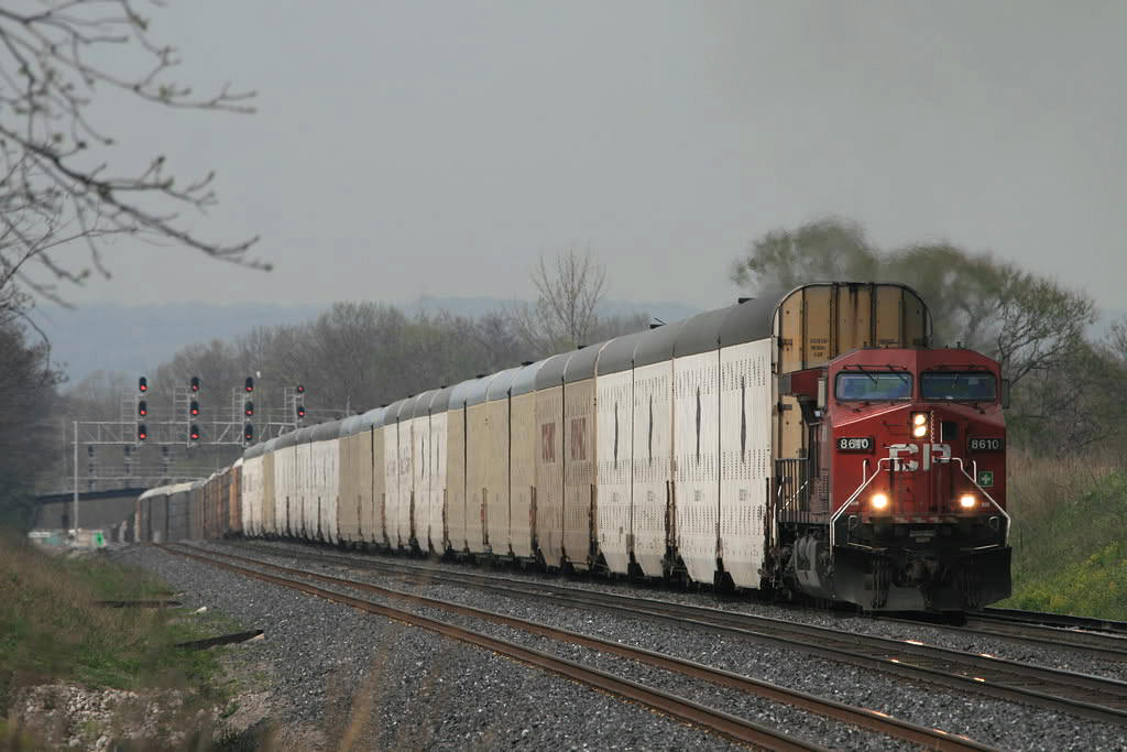 Dwarfed. You don't realize how tall those auto max cars are...until a large cut dwarfs the power...here CP 427 heads east on the CN at Aldershot
