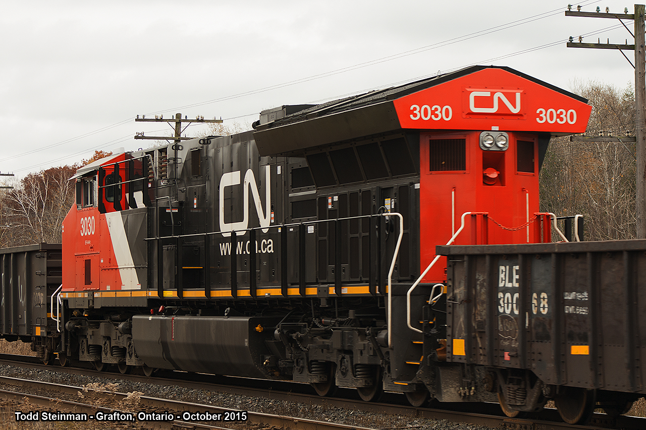 STUCK IN THE MIDDLE!  This was the first surprise of my day while at the Station Road crossing in Grafton. CN 3030 is found in the midst of train 305. This is the first train in my 30+ years of railfanning on the Kingston Subdivision that I saw this arrangement, although as fellow rp.ca user 'mberry' pointed out - this is common. To see CN 305 approach Grafton: http://www.railpictures.ca/?attachment_id=21409