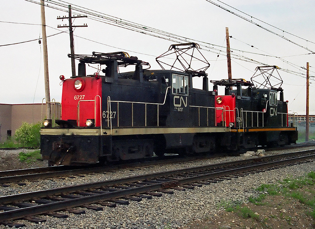CN Z5a-class "Steeplecab" electrics 6727 and 6725 (built by GE in 1950) at Eastern Junction the last week of May 1995.  Along with CN's boxcab electrics, they rostered three GE Steeplecabs numbered 6725-6727.

CN 6715 and 6710 at East Junction: http://www.railpictures.ca/?attachment_id=20232
Sister steeplecab electric 6726: http://www.railpictures.ca/?attachment_id=20616