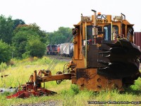 Sometimes, when photographing - you just never know what you will find in or around the railway yard. Here on this warm August evening, CN 68919 - a grass cutter / weed removing maintenance of way equipment, sits peacefully on a siding at Brantford. In the distance, just visible is CN 5752, CN 5692 and another CN unit. They are just completing a swap of cars in the Brantford yard, and will soon re-couple onto the rest of their train and depart Brantford.