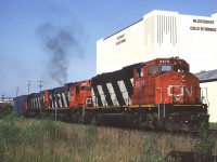 Canadian National GP40-2W 9579 (with a pair of MLWs trailing) leads Toronto - Fort Erie train #433 past the Aldershot Cold Storage plant at the west end of Aldershot. They are likely making a lift from Aldershot yard as eastbound trains would setout Niagara-bound traffic for pickup by #433. 