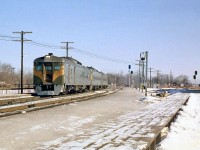 Westbound Canadian National Railiners (CN's term for Budd RDC cars) pass Port Credit station, on a "shoe fly" built during construction of the underpass for Hurontario Street (Highway 10) in the Winter of 1962. The station, along with the Oakville Subdivision's normal right-of-way alignment, platforms and signals can be seen on the right, with construction going on in the background where the line intersected the highway. Temporary signals and platforms were build along the shoe fly for passengers to embark/disembark at the station. <br><br> <b><u>More at Port Credit:</u></b><br> CN 2602 crossing the Credit River bridge: <a href="http://www.railpictures.ca/?attachment_id=14124"><b>http://www.railpictures.ca/?attachment_id=14124</b></a><br> CN 4-8-4 "Northern" 6184 in 1958: <a href="http://www.railpictures.ca/?attachment_id=15317"><b>http://www.railpictures.ca/?attachment_id=15317</b></a> <br><br> [<i>Editor's note</i>: You can see the Port Credit shoe fly construction from 1962/1963 in the City of Toronto's online 1963 aerial imagery <a href="http://jpeg2000.eloquent-systems.com/toronto.html?image=ser12/s0012_fl1963_it0008.jp2"><b>*here*</b></a>.]
