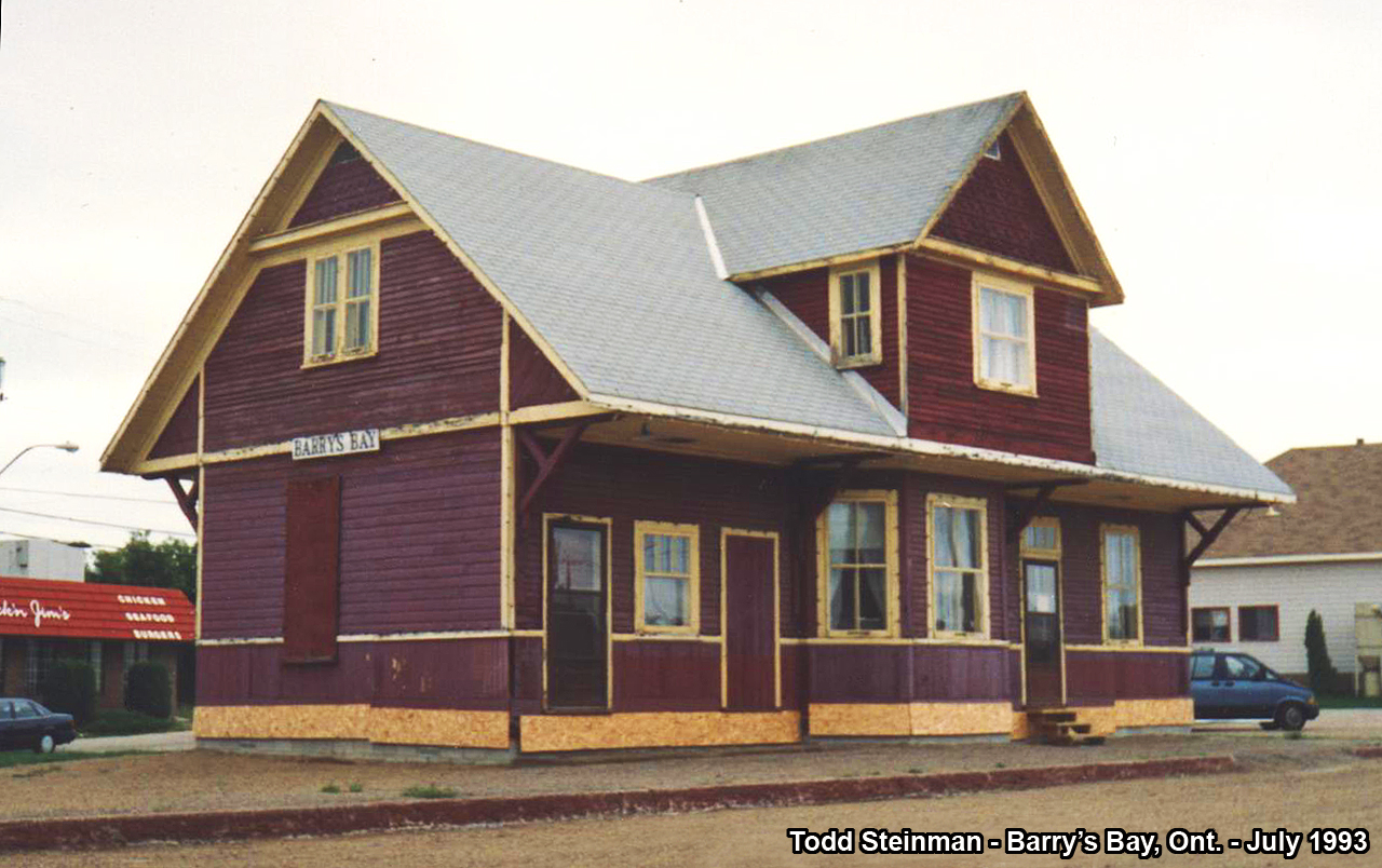 On a family vacation in the Ottawa Valley, my surprise was when we arrived in Barry's Bay to find this gem. At the time of this photo, the tracks had been removed for maybe a year or two...and the station was in the early stages of restoration (it's end use was a Tourist Information Center). This station is the last remaining of it's style along this portion of the line (originally built by the Ottawa, Arnprior & Parry Sound Railway). Many more had already been demolished at Killaloe, Wilno, Carp, etc. Today, where the tracks once were laid, is now a small park. Of note - also from the days of railroading, the water tower still stands at Barry's Bay. as it was a junction point for lines branching off to not only Renfrew, but to Pembroke as well as all points in between.