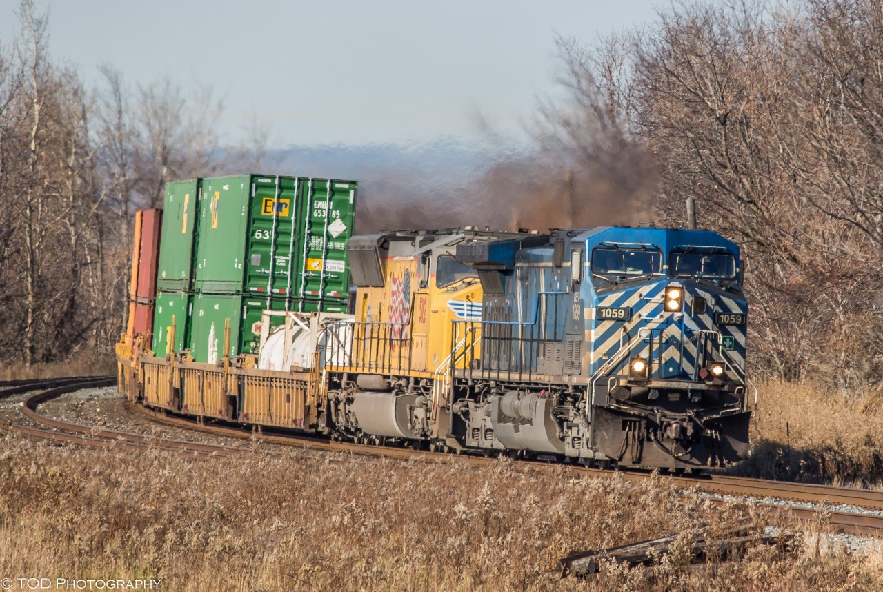 After filming this pair a few days earlier on CP 143 at Midnight, I was more than happy to hear this pair was back on 142 on a beautiful Fall day. 

CP 142 comes around the bend at Lovekin with a Bluebird CEFX on point, and a UP SD70M trailing. (11:45)