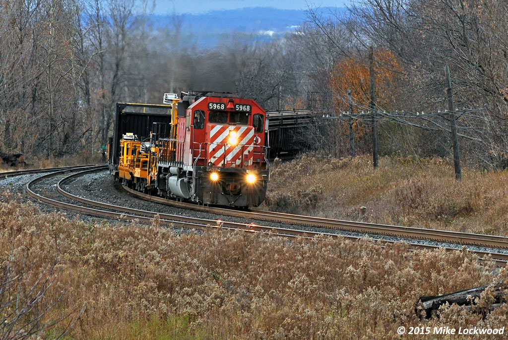 At the midway point of the chase, eastbound CWR train passes Lovekin Siding with CP 5968 as sole power on the diminutive train. 1449hrs.