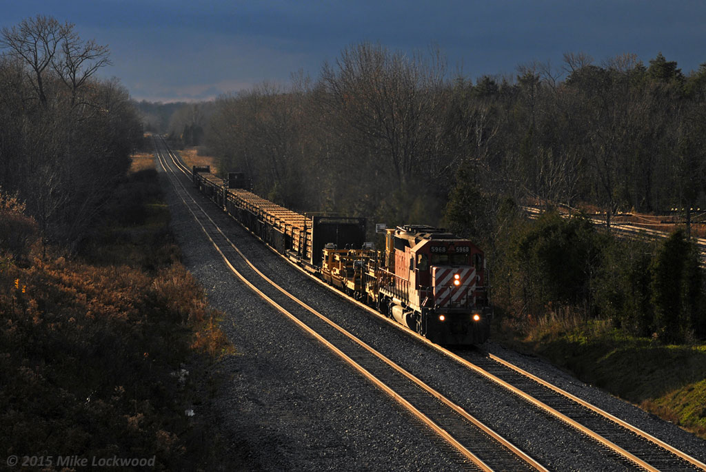 A break in the gloom provides a bit of dramatic lighting as CP 5968 leads eastbound CWR along Spicer siding. 1539hrs.