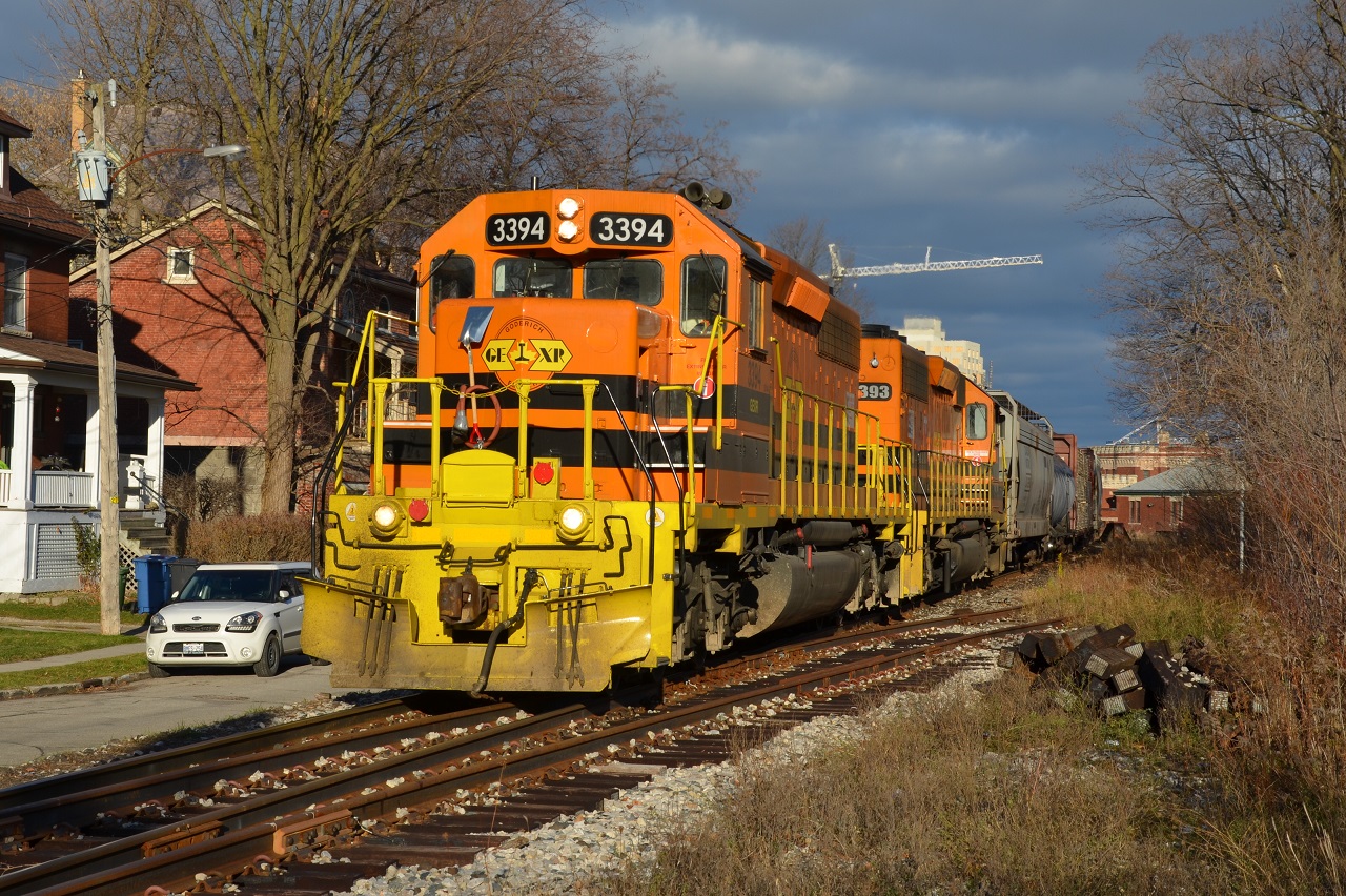 Cranes, Trains, and Automobiles are all pictured here as GEXR 431 crawls through downtown Guelph along side Kent St.