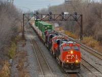 CN 120 has three ES44AC's and and a fourth mid-train (CN 2938,CN 2855, CN 2936 and DPU CN 2917) as it leaves Taschereau Yard on a grey morning. 