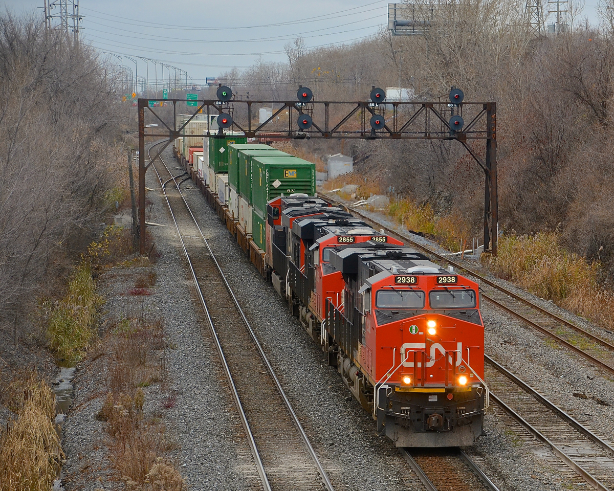 CN 120 has three ES44AC's and and a fourth mid-train (CN 2938,CN 2855, CN 2936 and DPU CN 2917) as it leaves Taschereau Yard on a grey morning.
