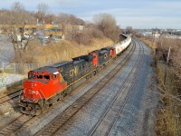 <b>CN's first Dash9 leading the TankTrain.</b> CN 2500 (CN's first Dash9) and CN 8877 head west with CN 785 just as the sun pops out. This unit train transports gas from the refinery in St-Romuald, Quebec to the Ultramar terminal in Maitland, Ontario. 