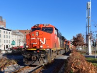 <b>Intermodal through Old Montreal.</b> Stack train CN 149 (Montreal-Chicago) has just left Port of Montreal trackage and is passing through historic Old Montreal with ES44AC's CN 2872 & CN 2856 as power on a sunny morning.