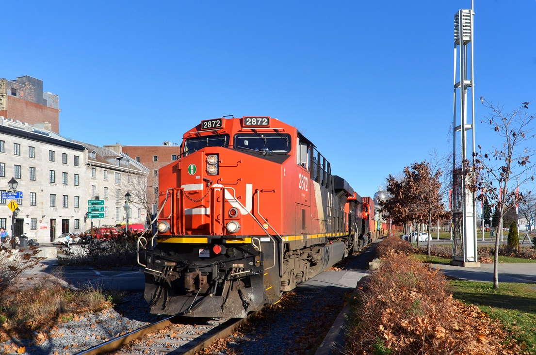 Intermodal through Old Montreal. Stack train CN 149 (Montreal-Chicago) has just left Port of Montreal trackage and is passing through historic Old Montreal with ES44AC's CN 2872 & CN 2856 as power on a sunny morning.