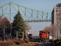 <b>CN 149, with CP lurking.</b> A CP GE is seen lurking to the left of CN 2103, which is leading CN 149. Both trains are on Port of Montreal Tracks. 